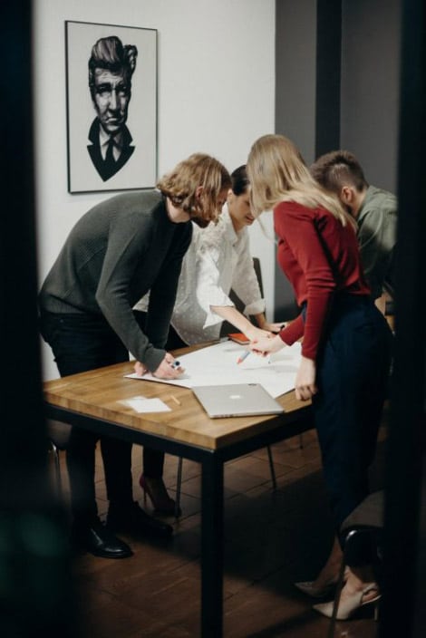 women-and-men-standing-near-table-3205568-1